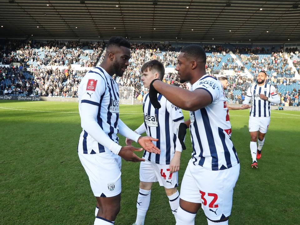 Daryl Dike and Jovan Malcolm slap hands on the pitch before kick-off against Aldershot