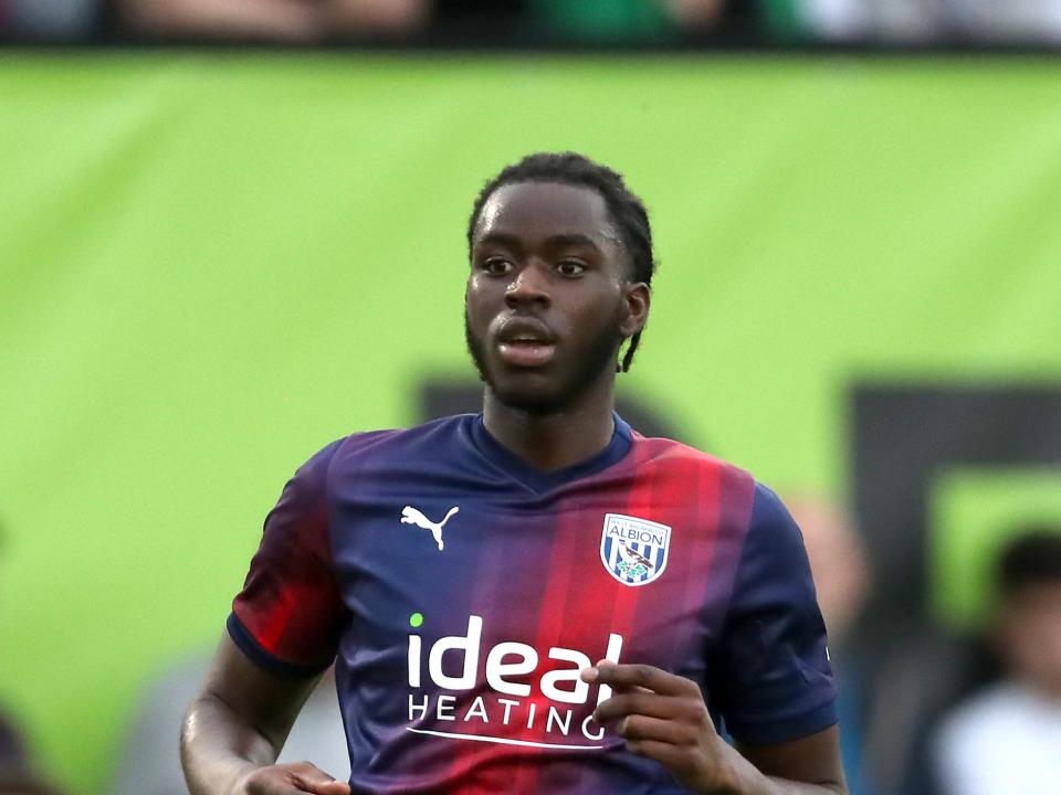 Mo Faal in Albion action in the navy blue and red kit