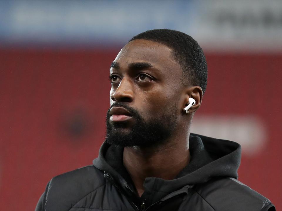 Semi Ajayi with headphones in staring up