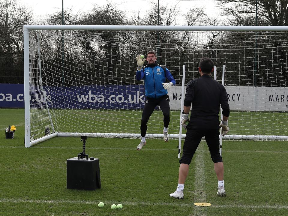 Alex Palmer working with a tennis ball and goalkeeping coach Marcos Abad
