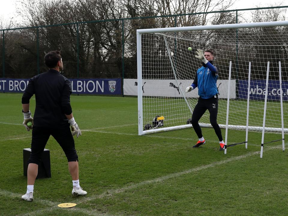 Josh Griffiths working with a tennis ball and goalkeeping coach Marcos Abad