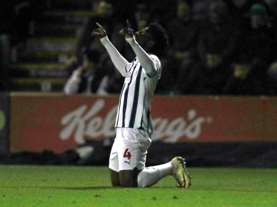 Cedric Kipre on his knees pointing at the sky with both hands after scoring against Plymouth 