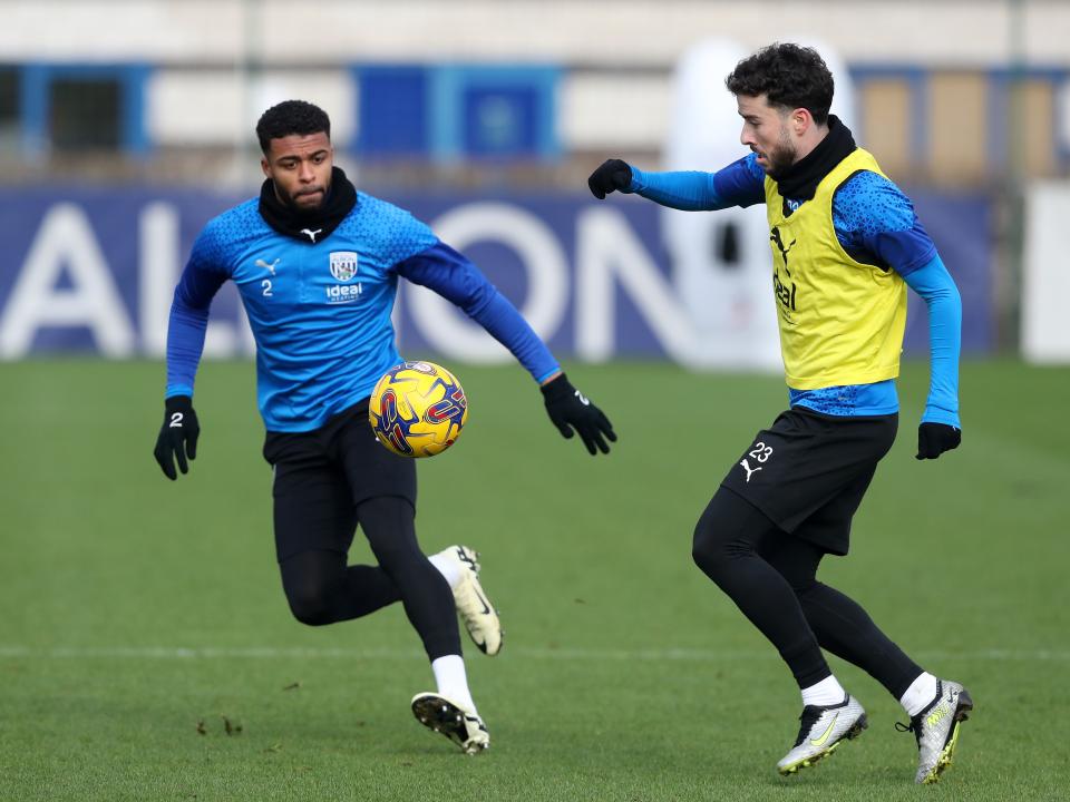 Mikey Johnston and Darnell Furlong chase the ball in training 