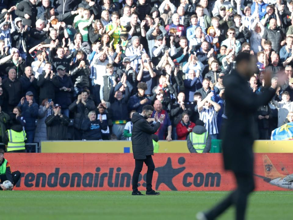 Carlos Corberán applauding Albion fans in the background at the MKM Stadium