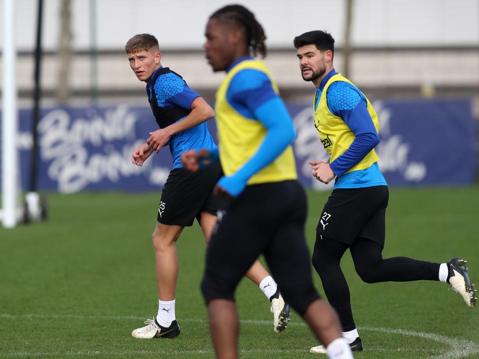 Callum Marshall, Alex Mowatt and Brandon Thomas-Asante running forward during a training session