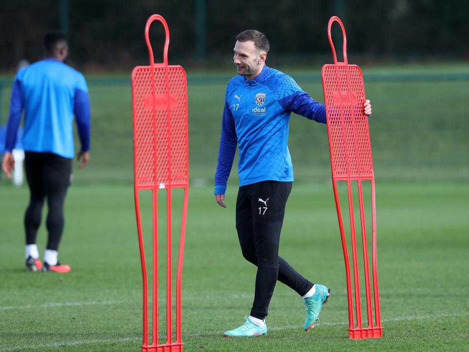 Andi Weimann holding a mannequin during a training session