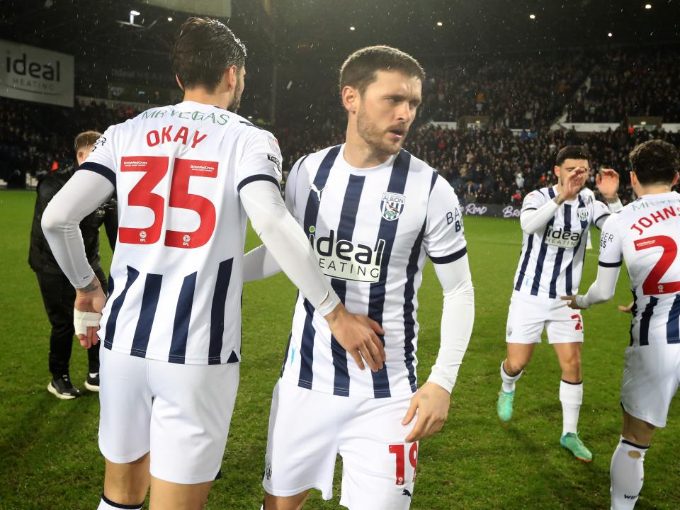 Okay Yokuslu and John swift on the pitch together before kick-off