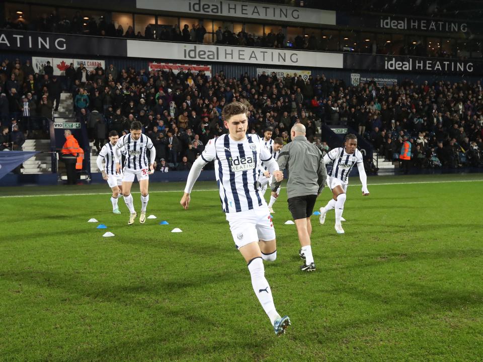 Tom Fellows warming up on the pitch moments before kick-off