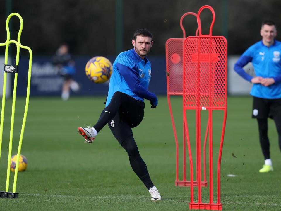 John Swift shoots at goal during training 