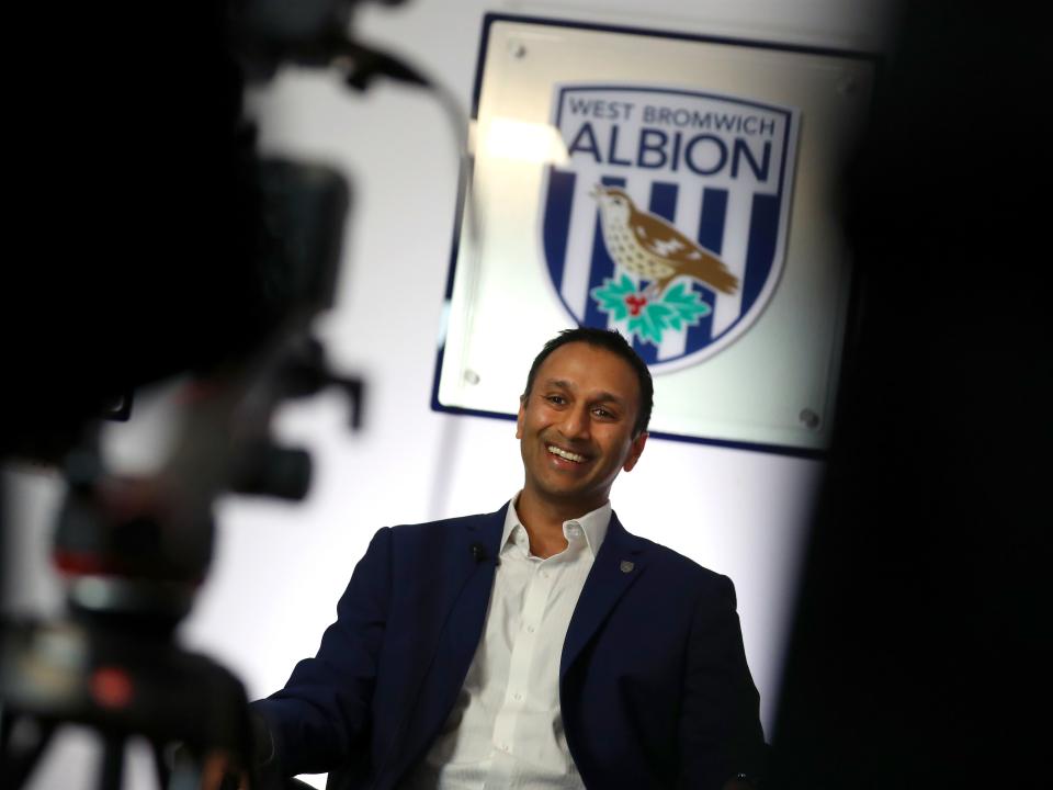 Shilen Patel is interviewed in front of a big Albion badge 