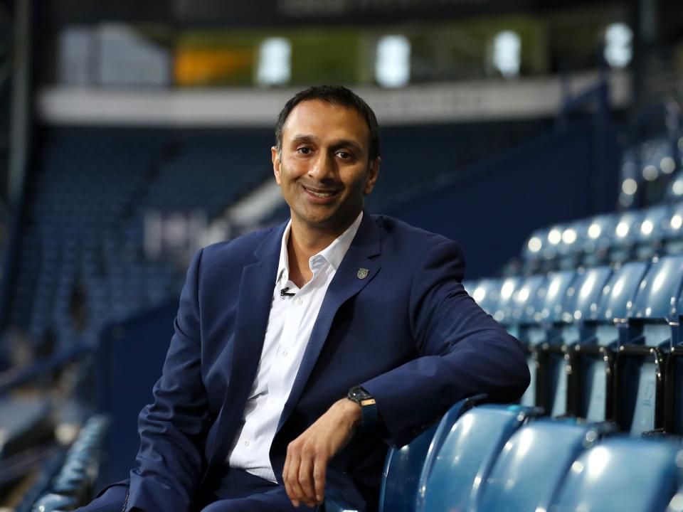 Shilen Patel sat in the West Stand at The Hawthorns in a suit smiling at the camera