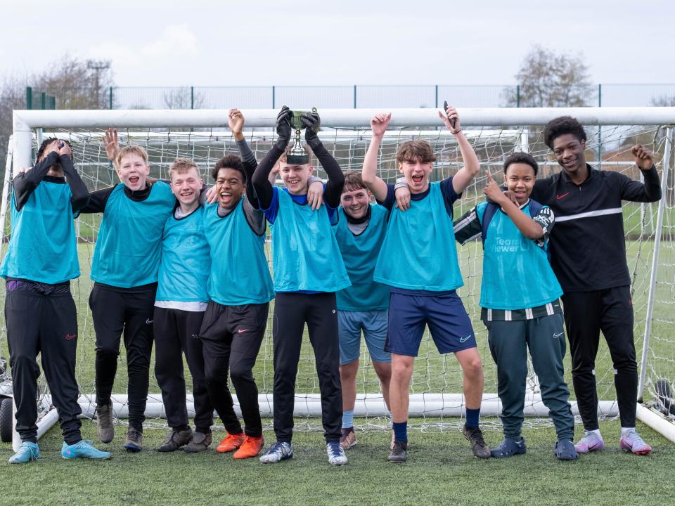 PL Kicks tournament winners celebrate with trophy