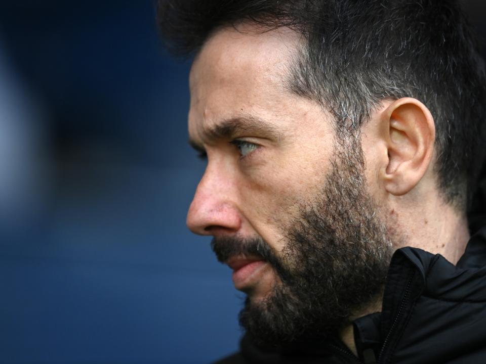 A close up of the side of Carlos Corberán's face