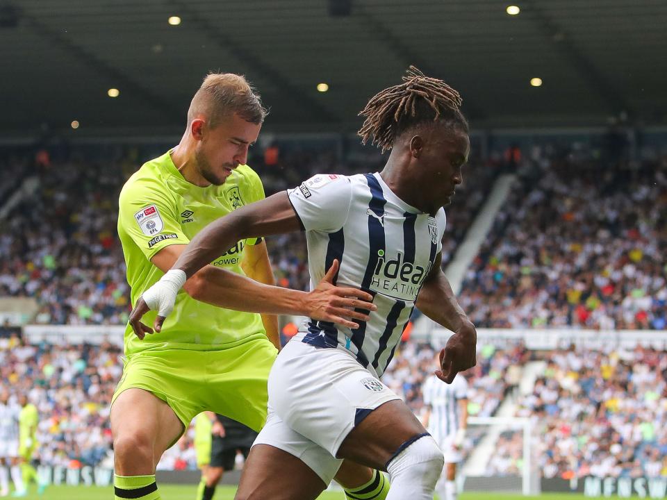A Huddersfield Town player chases Brandon Thomas-Asante at The Hawthorns