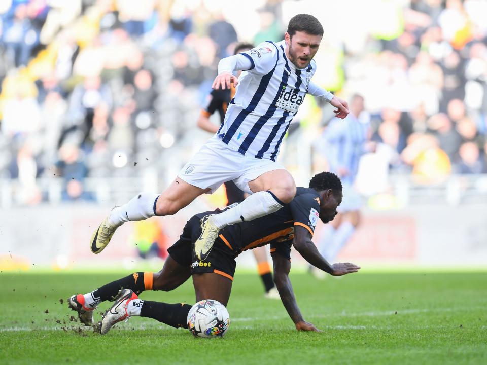 John Swift jumps over a Hull City challenge when in possession of the ball