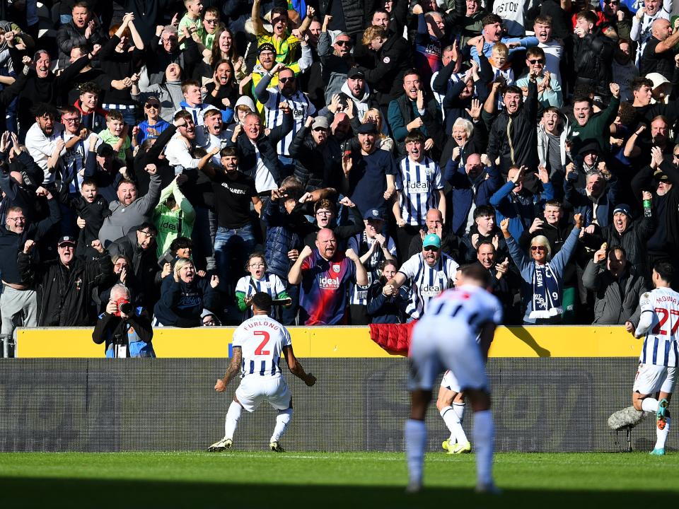 Darnell Furlong celebrates his goal against Hull with Albion fans in front of him