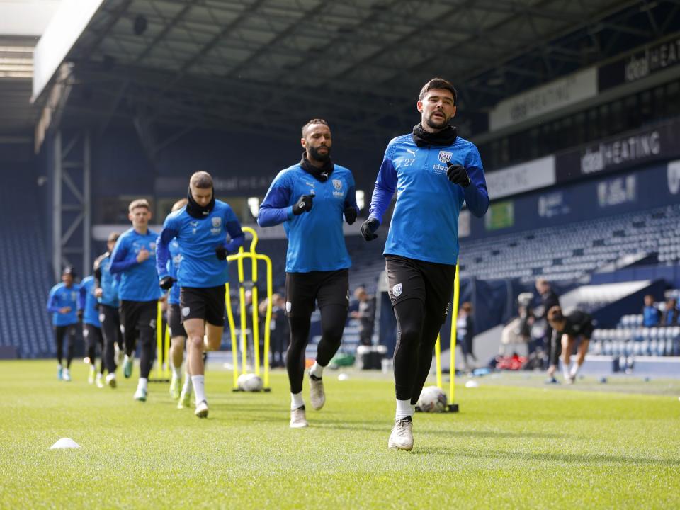 Albion players warming up on the pitch at The Hawthorns during a training session