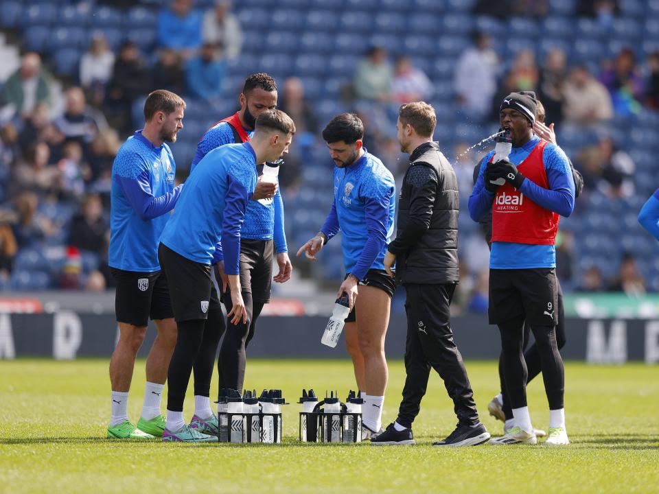 Albion players pause during a training session at The Hawthorns to take on some fluids 