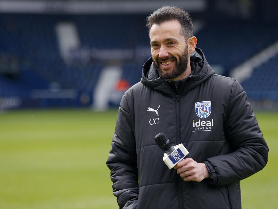 Carlos Corberán holding a mic talking to supporters at The Hawthorns