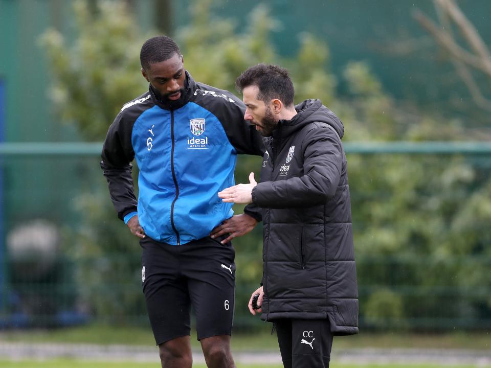 Carlos Corberán delivering information to Semi Ajayi out on the training pitches