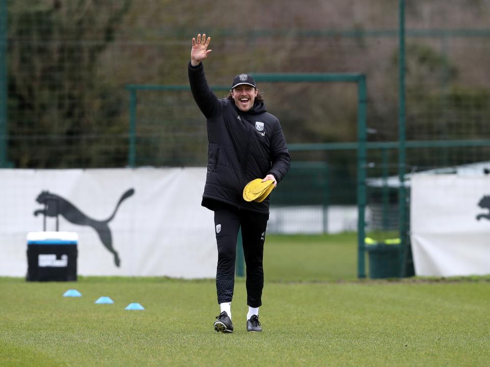 Michael Hefele waving at the camera while out on the training pitch