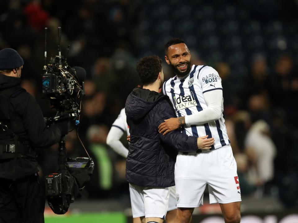Mikey Johnston and Kyle Bartley embrace after beating Coventry 