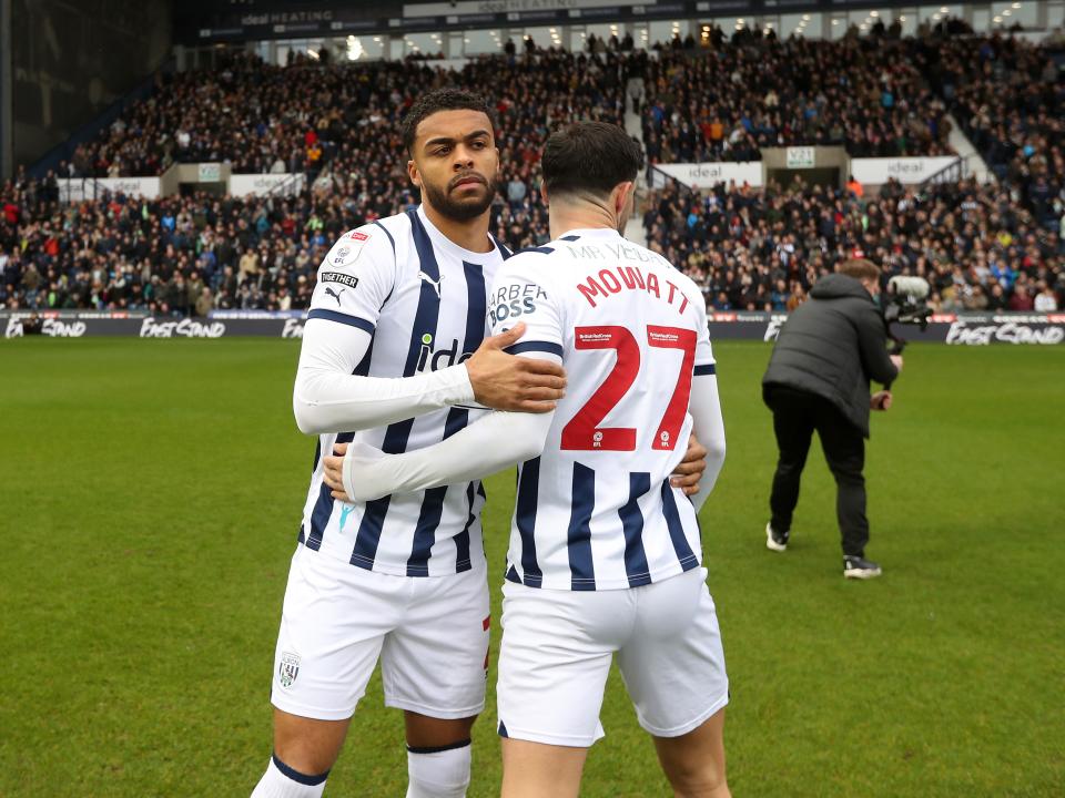 Alex Mowatt and Darnell Furlong embrace on the pitch before the game against Bristol City