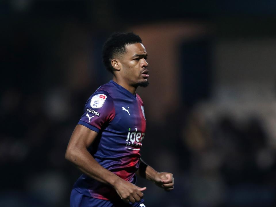 Grady Diangana in action for Albion at QPR while wearing the navy-blue-and-red away kit