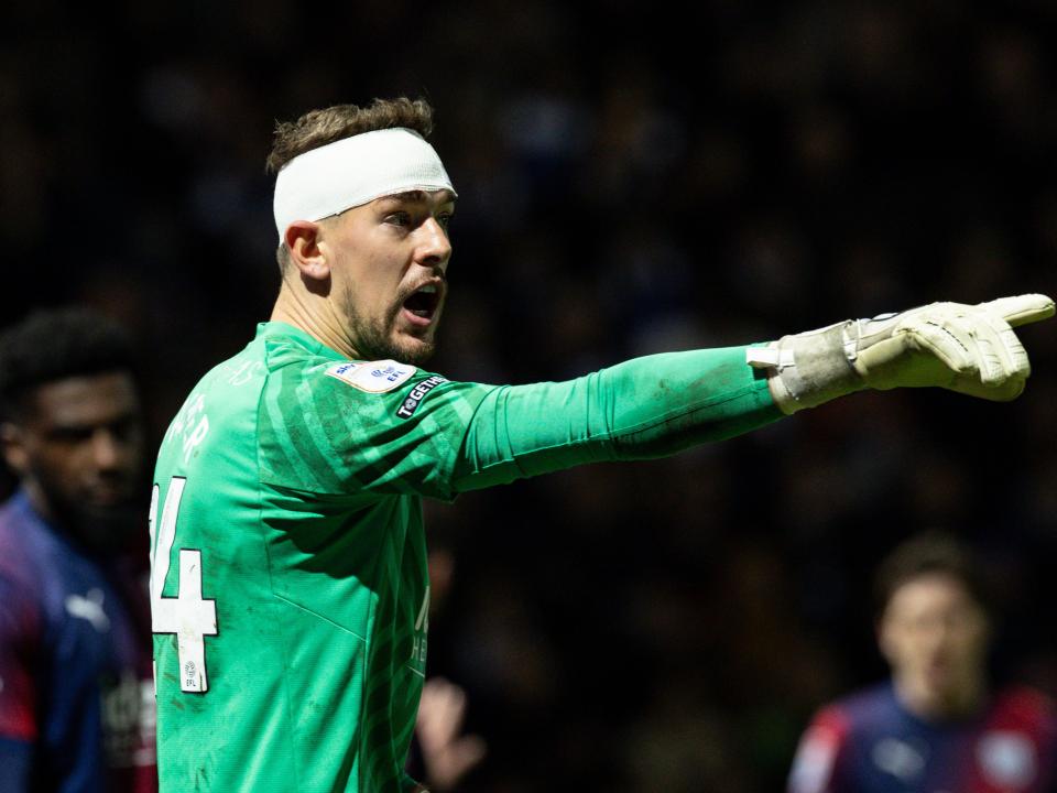 Alex Palmer pointing during the game against QPR while wearing a bandage around his head