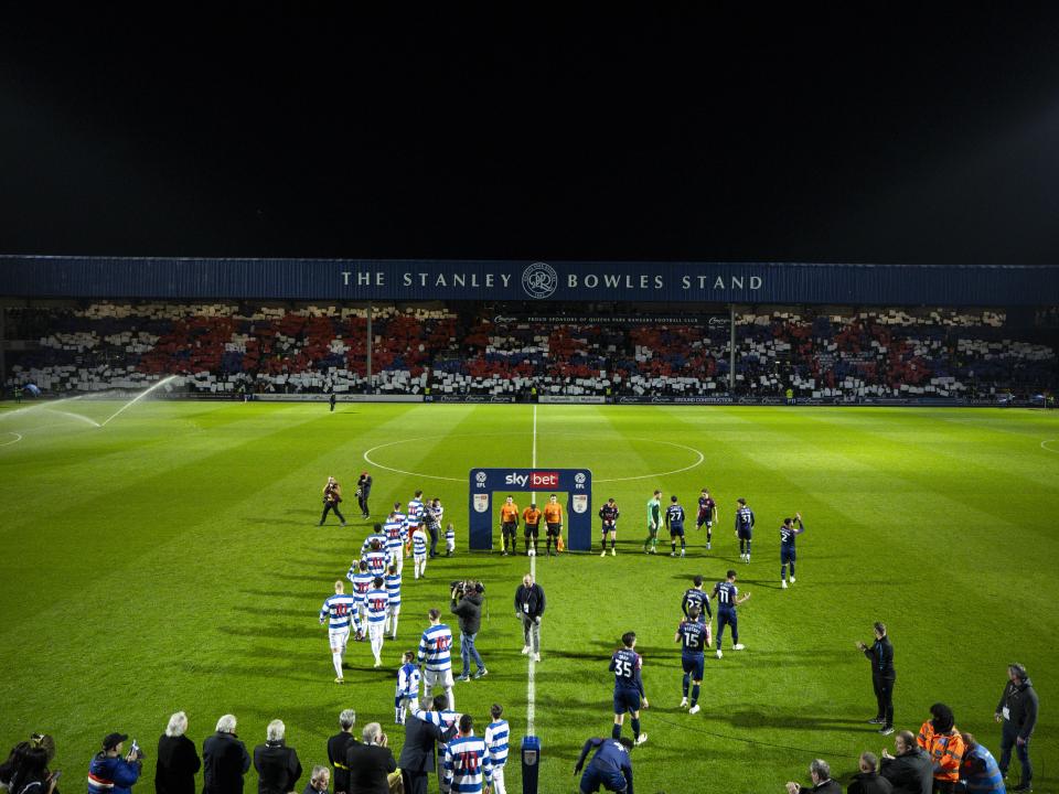 QPR and Albion players walk out on to the pitch before the game at Loftus Road