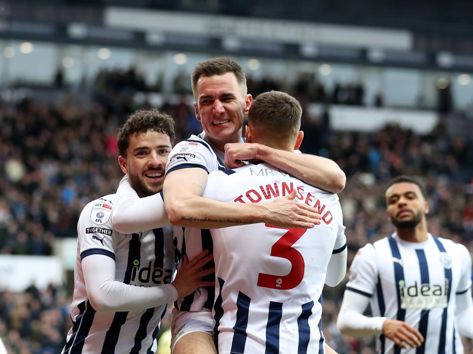 An image of Jed Wallace celebrating a goal with Conor Townsend and Mikey Johnston