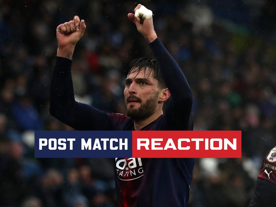 Okay Yokuslu celebrates scoring at Huddersfield with his arms in the air