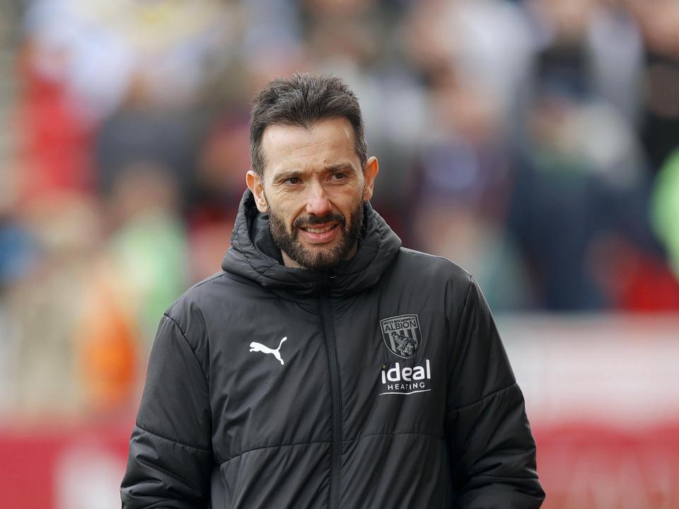 Carlos Corberán wearing a black Albion coat