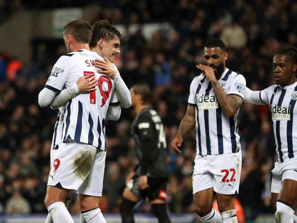 John Swift celebrates scoring against Rotherham United with several team-mates 