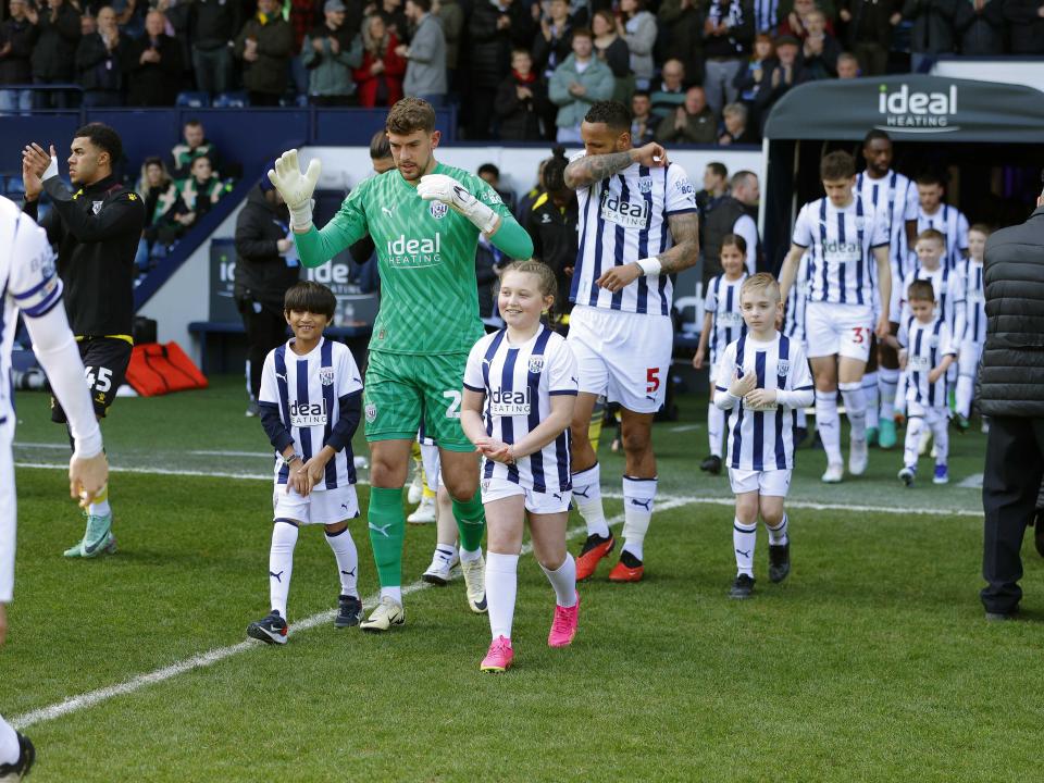 Alex Palmer walking out of the tunnel at The Hawthorns against Watford with two mascots