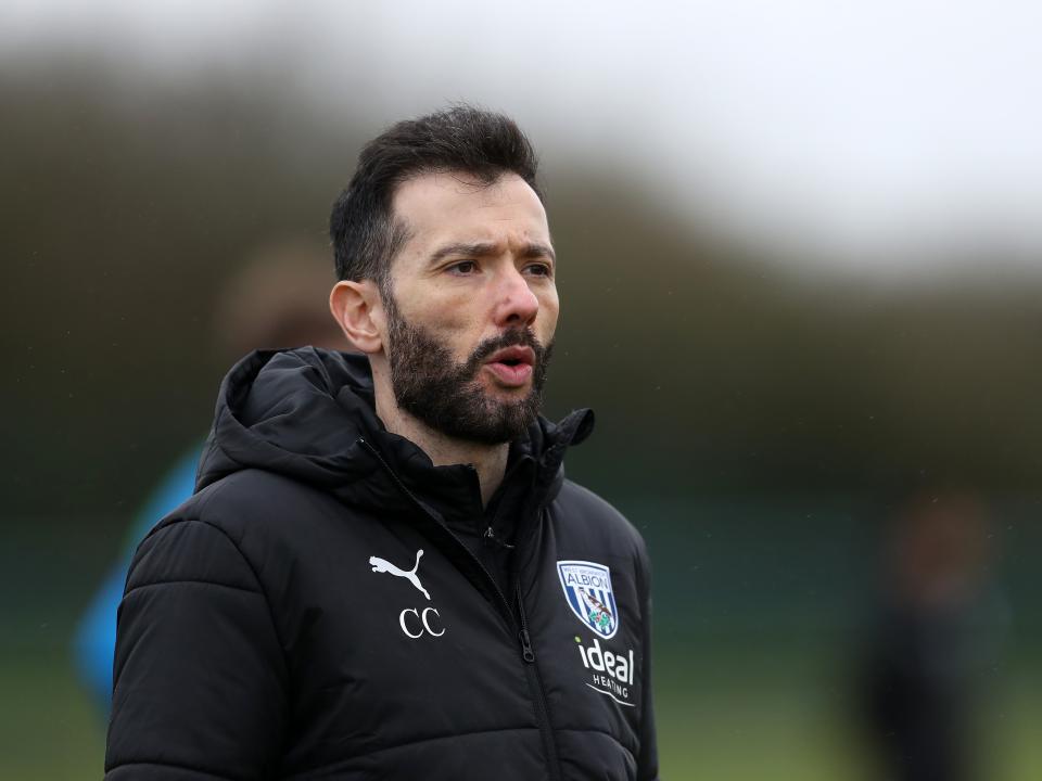 Carlos Corberán wearing a black Albion coat during the middle of a training session