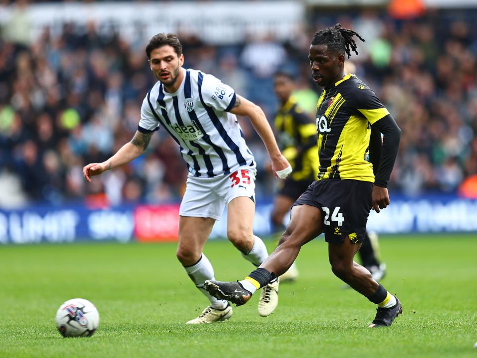 Okay Yokuslu closely watching a Watford player on the ball 