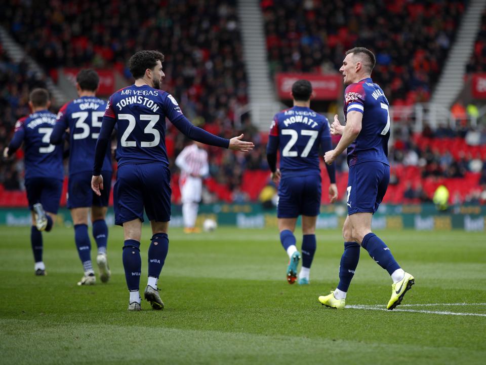 An image of Jed Wallace and Mikey Johnston high-fiving at Stoke