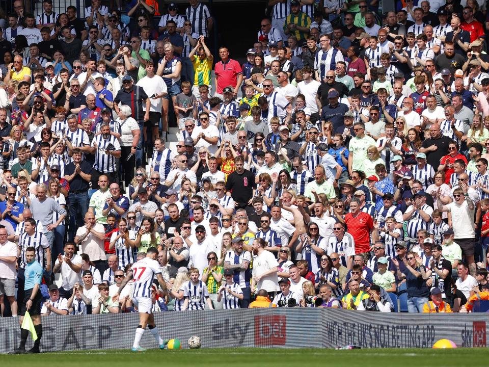 Alex Mowatt prepares to take a corner against Southampton at The Hawthorns with several Albion fans behind him