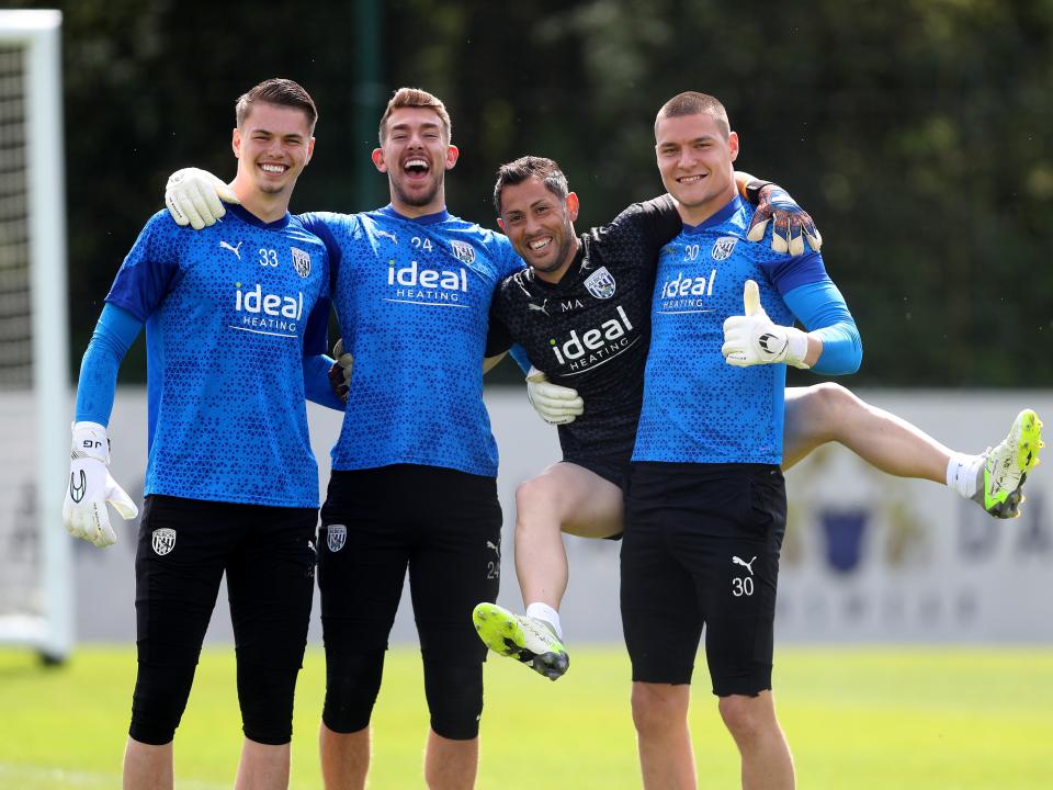 Albion goalkeepers Alex Palmer, Ted Cann and Josh Griffiths pose for a photo with goalkeeping coach Marcos Abad