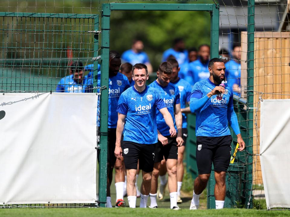 Jed Wallace leads Albion players out onto the training pitch 
