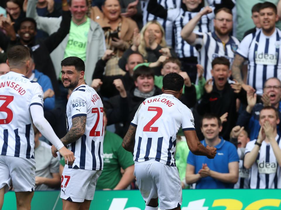 Darnell Furlong celebrates scoring against Preston with team-mates and fans