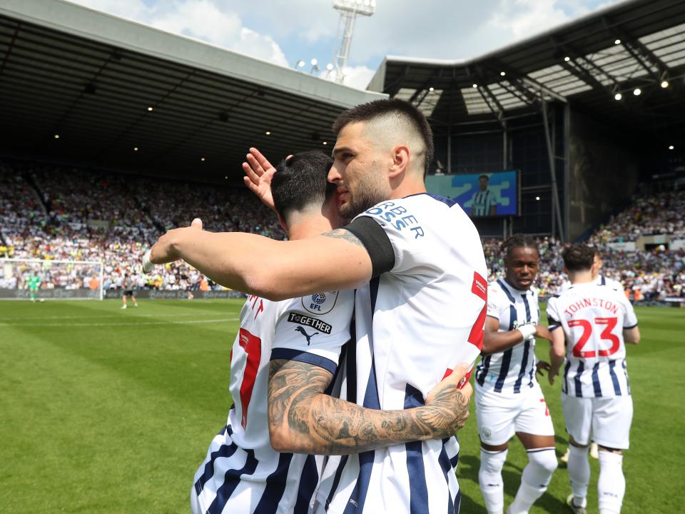 Okay Yokuslu hugs Alex Mowatt on the pitch before the game against Southampton at The Hawthorns 