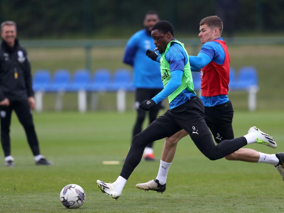 Josh Maja and Conor Townsend fighting for the ball during a training session