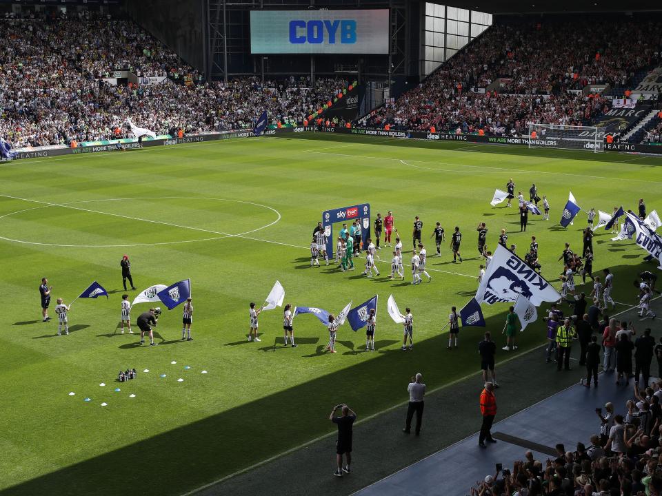 A general view of the two teams stepping out onto the pitch at The Hawthorns 