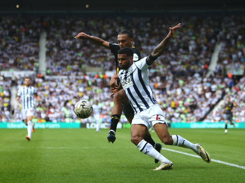 Darnell Furlong fights for the ball against a Southampton player at The Hawthorns 