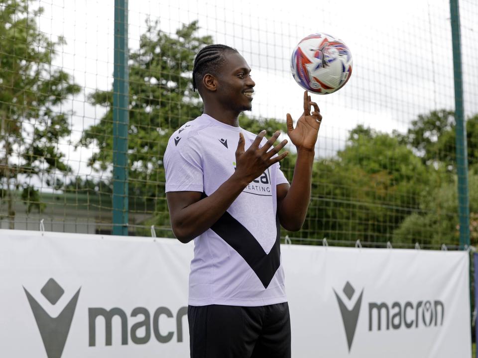 Ousmane Diakité smiling while juggling a football