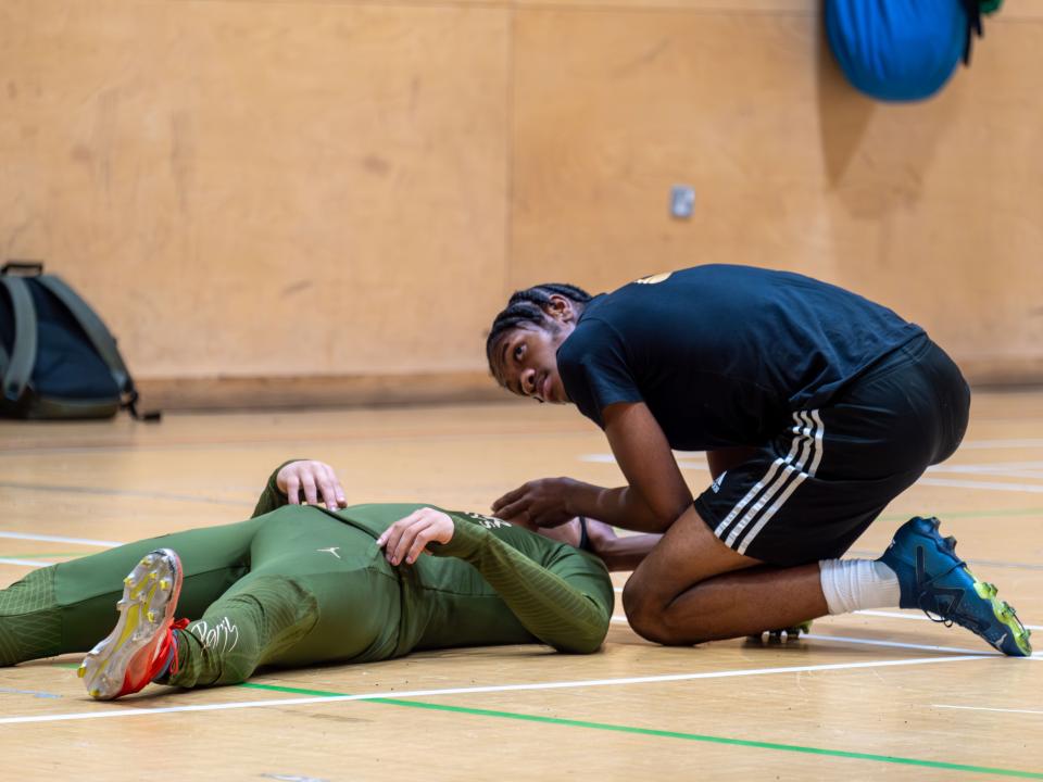Participant checking vitals during Street First Aid workshop.