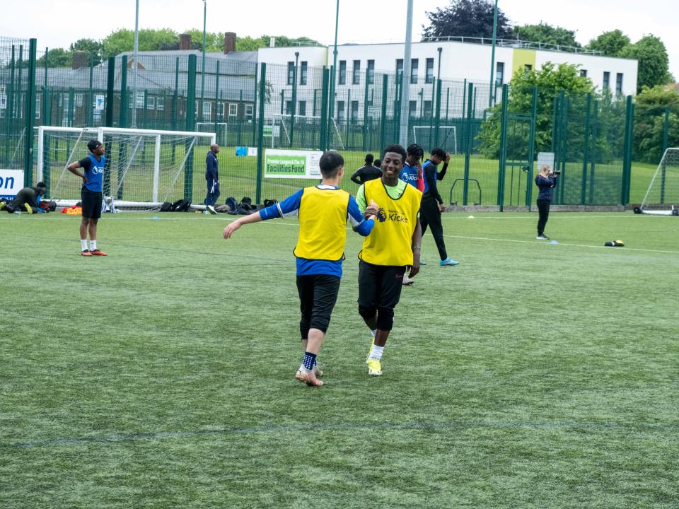 Teammate embrace after the game (yellow bibs)