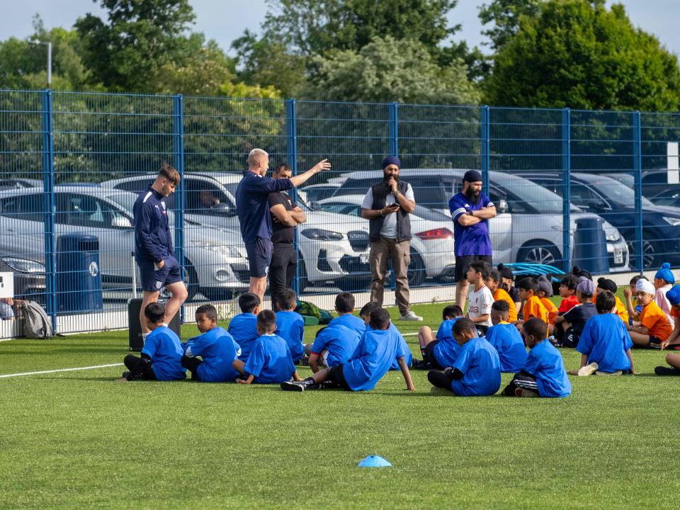 Participants at our South Asian Emerging Talent Festival receive instructions from The Albion Foundation coaches on the Academy pitch.